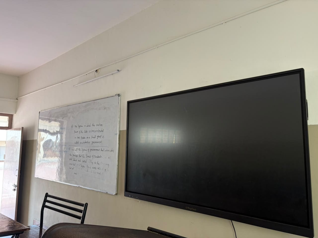 A classroom at Mandaara Public School, showing the whiteboard and the wall-mounted display panel used in lessons.