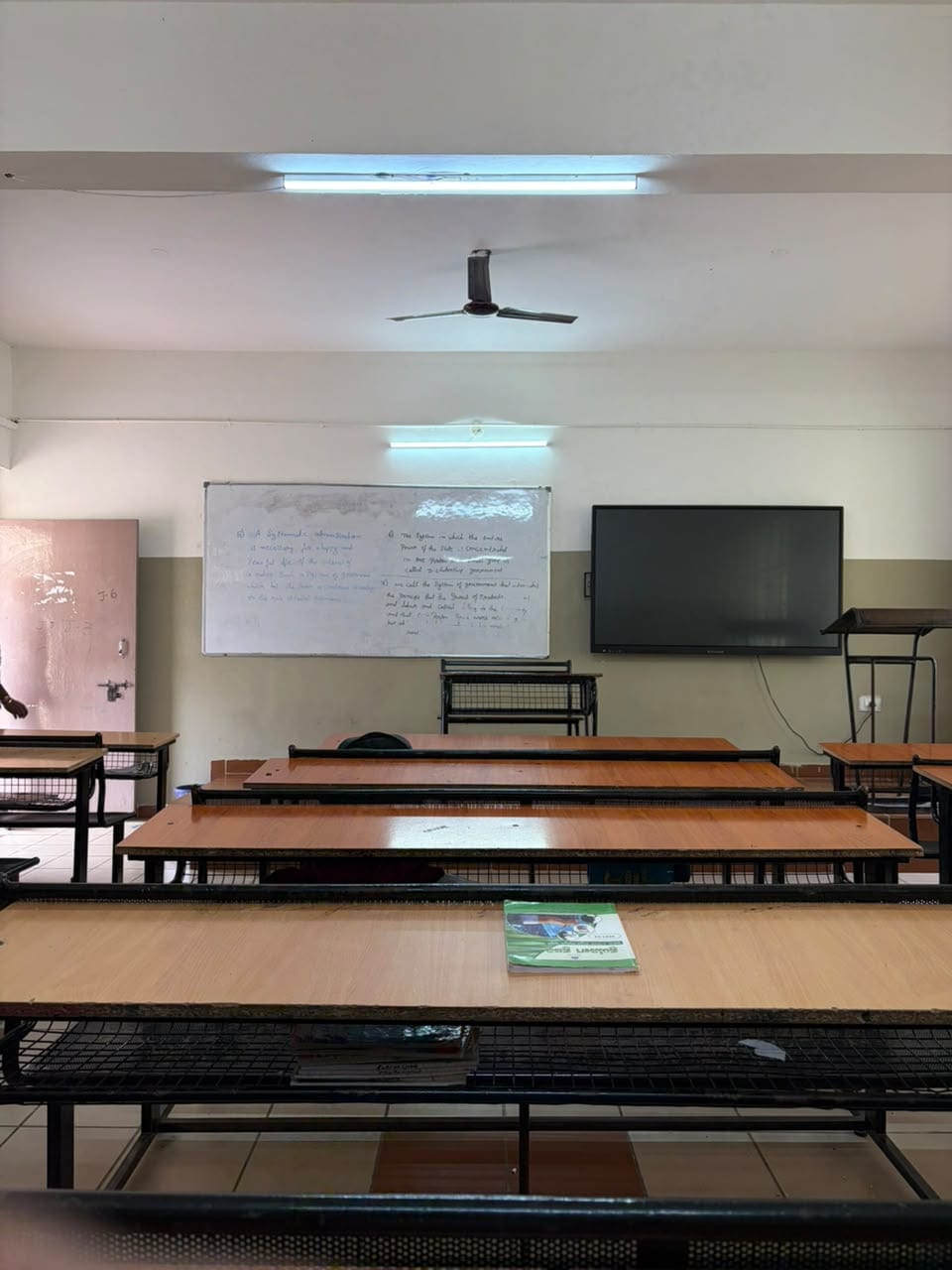A classroom at Mandaara Public School, with rows of desks facing a whiteboard and a display panel.