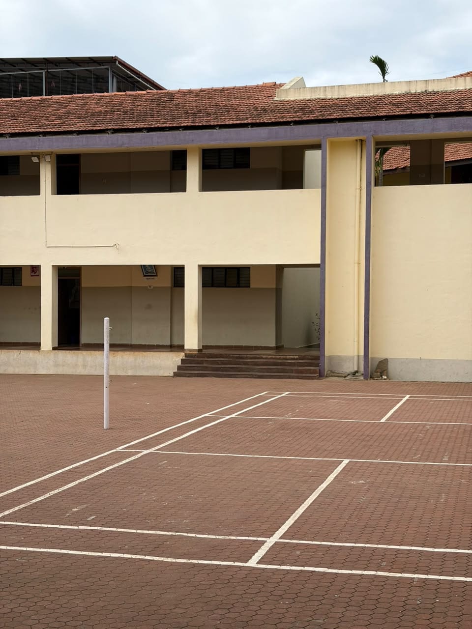 The Mandaara Public School building at Doddabathi, seen across the paved courtyard.